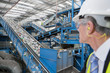 Photo: Technician using measurement probe on assembly line in steel bearing manufacturing plant Technician using measurement probe on assembly line in steel bearing manufacturing plant