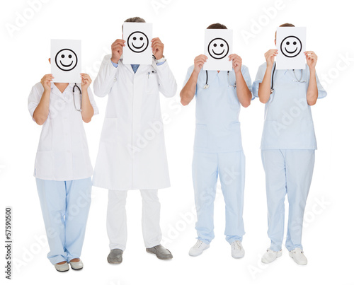 Photo: Group Of Doctors Holding Smiley Icon Group Of Doctors Holding Smiley Icon