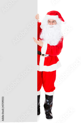 Photo: Portrait of a santa holding blank placard Portrait of a santa holding blank placard