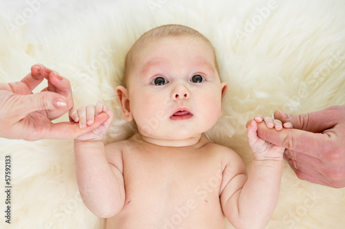 Photo: baby girl holding parental hands baby girl holding parental hands