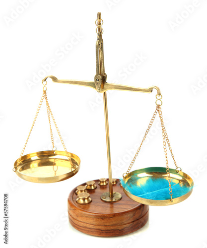 Photo: Balance scale with feather isolated on white Balance scale with feather isolated on white