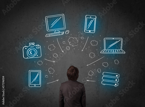 Photo: Businessman with multimedia icons over his head Businessman with multimedia icons over his head