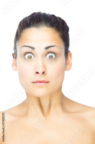 Photo: Front view of shocked brunette woman looking at camera Front view of shocked brunette woman looking at camera
