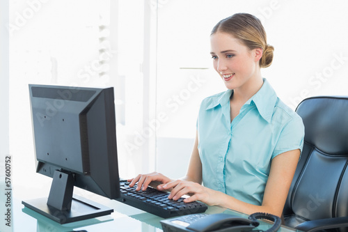 Photo: Classy happy businesswoman working at computer Classy happy businesswoman working at computer