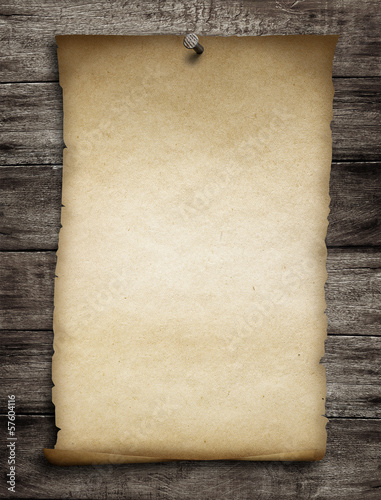 Photo: old wanted paper or parchment pinned by nail to grunge wooden ba old wanted paper or parchment pinned by nail to grunge wooden ba