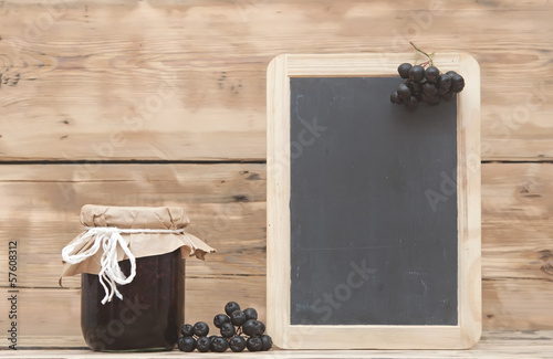 Photo: Black chokeberry jam on wooden table Black chokeberry jam on wooden table