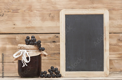 Photo: Black chokeberry jam on wooden table Black chokeberry jam on wooden table