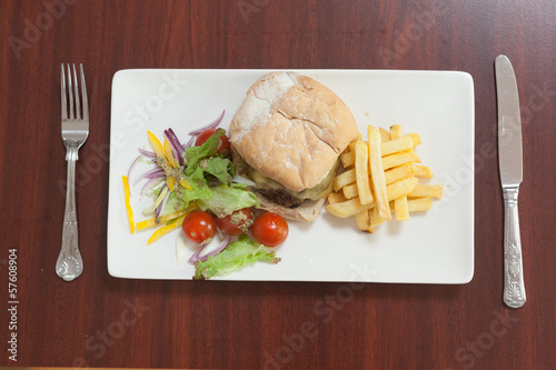 Photo: Overhead view of burger with french fries and salad Overhead view of burger with french fries and salad