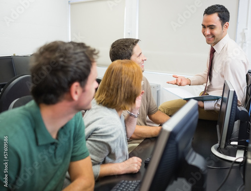 Photo: Teacher and mature students in computer room Teacher and mature students in computer room
