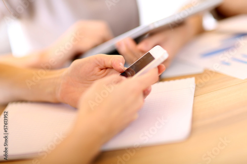 Photo: Closeup of smartphone used in office Closeup of smartphone used in office