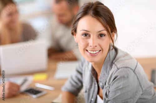 Photo: Young woman attending business training class Young woman attending business training class