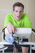 Photo: Portrait of serious runner holding mask and leaning on treadmill in sports science laboratory Portrait of serious runner holding mask and leaning on treadmill in sports science laboratory
