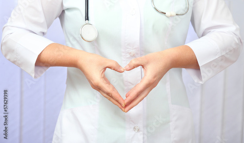 CONTENT::IMG::TITLE::Photo: Close up of doctor hands making heart shape Close up of doctor hands making heart shape