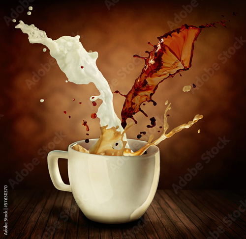 Photo: Coffee With Milk Splashing. Cup of Cappuccino or Latte Coffee With Milk Splashing. Cup of Cappuccino or Latte