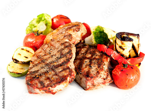 Photo: Grilled Beef Steak with Vegetables over White Background Grilled Beef Steak with Vegetables over White Background