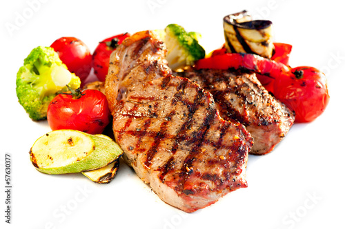 Photo: Grilled Beef Steak with Vegetables over White Background Grilled Beef Steak with Vegetables over White Background