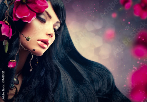 Photo: Beauty Brunette Model Girl with Big Purple Flowers in her Hair. Beauty Brunette Model Girl with Big Purple Flowers in her Hair.