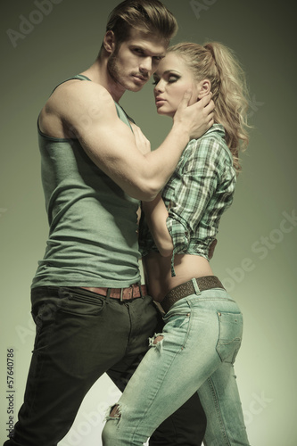 Photo: man holding her face in his palm and looking at the camera man holding her face in his palm and looking at the camera