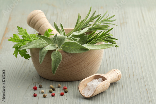 Photo: mortar and pestle with herbs and spices mortar and pestle with herbs and spices