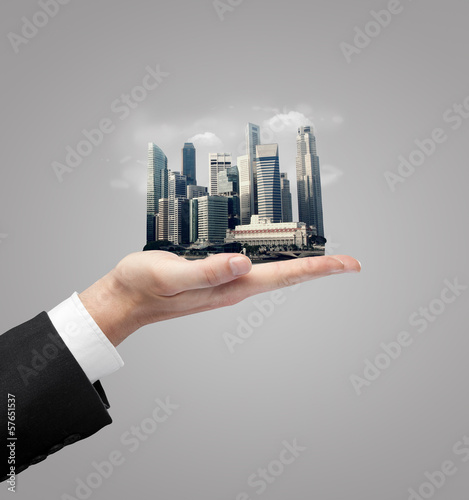 Photo: hand holding skyscraper hand holding skyscraper