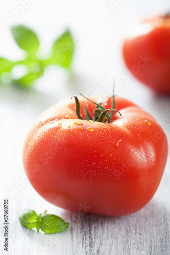 Photo: fresh big tomatoes and basil leaves fresh big tomatoes and basil leaves