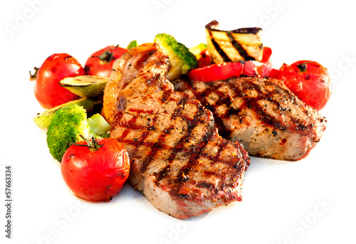 Photo: Grilled Beef Steak with Vegetables over White Background Grilled Beef Steak with Vegetables over White Background