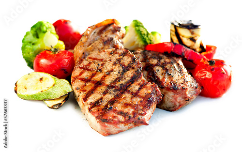 Photo: Grilled Beef Steak with Vegetables over White Background Grilled Beef Steak with Vegetables over White Background