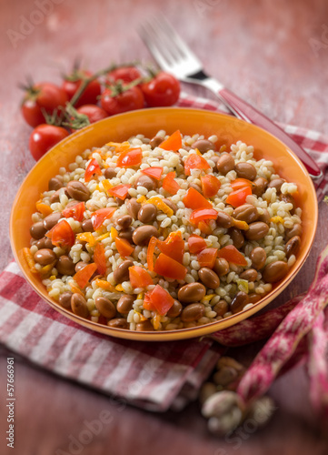 Photo: barley risotto with beans and tomatoes, selective focus barley risotto with beans and tomatoes, selective focus