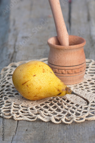 Photo: yellow juicy pear and wood mortar yellow juicy pear and wood mortar