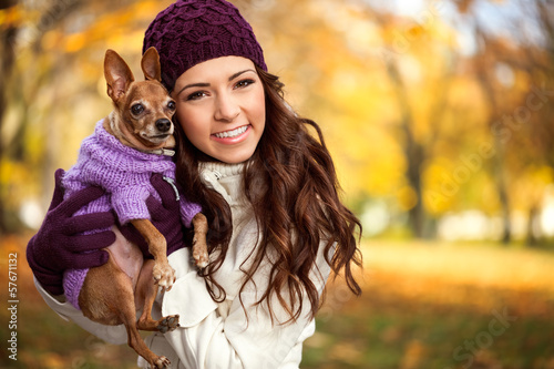 Photo: woman holding her puppy after in the park woman holding her puppy after in the park