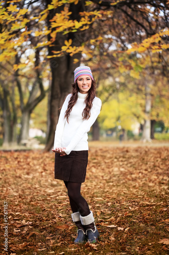Photo: Cute girl in autumn park Cute girl in autumn park