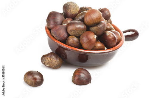 Photo: Bowl with chestnuts close up on the white Bowl with chestnuts close up on the white