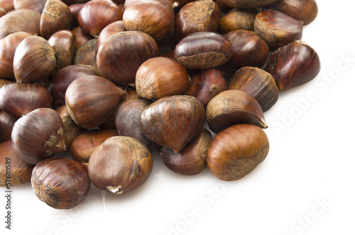 Photo: Delicious group of chestnuts close up background Delicious group of chestnuts close up background