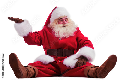 Photo: Hilarious and funny Santa Claus showing presenting gesture while Hilarious and funny Santa Claus showing presenting gesture while