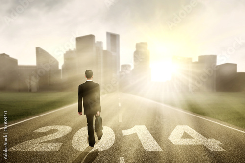 Photo: Businessman walking to the New Year 2014 Businessman walking to the New Year 2014