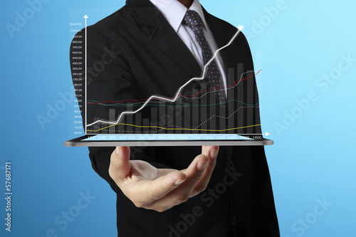 Photo: hand touch screen graph on tablet hand touch screen graph on tablet