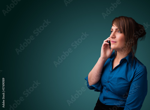 Photo: Young woman making phone call with copy space Young woman making phone call with copy space