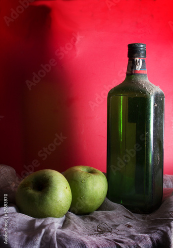 Photo: Antique wine or whiskey bottle with apples Antique wine or whiskey bottle with apples
