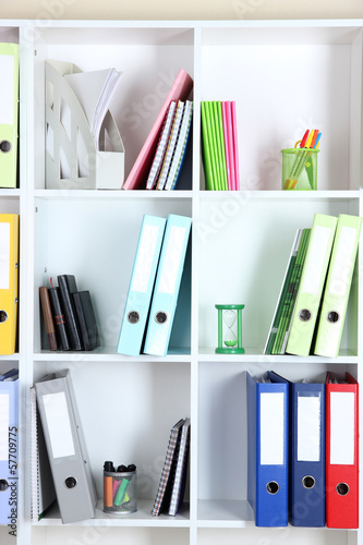Photo: White office shelves with folders and different stationery, White office shelves with folders and different stationery,