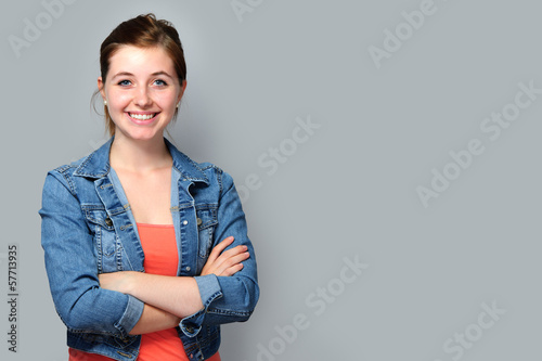 Photo: Teenage girl standing with crossed arms Teenage girl standing with crossed arms