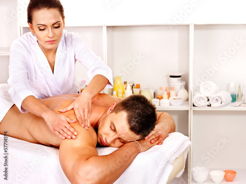 Photo: Man getting massage in spa. Man getting massage in spa.