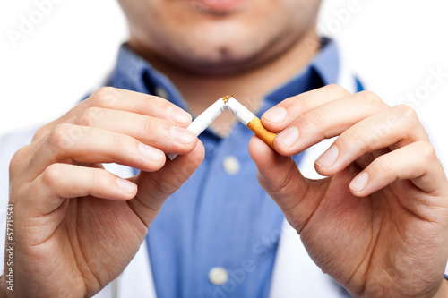 Photo: Doctor breaking a cigarette Doctor breaking a cigarette