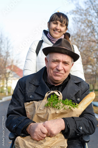 Photo: Smiling senior man with a bag of groceries Smiling senior man with a bag of groceries