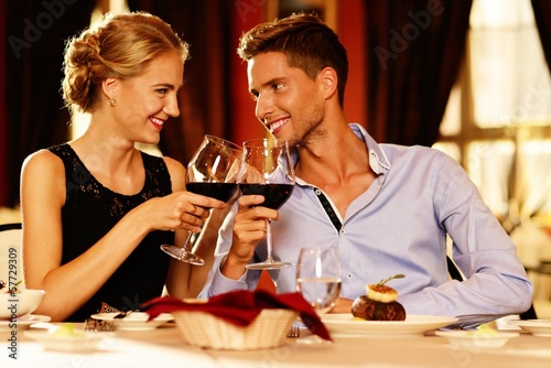 Photo: Beautiful young couple in restaurant Beautiful young couple in restaurant