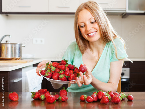Photo: woman eating strawberries woman eating strawberries