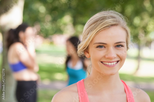 Photo: Beautiful blonde sporty woman posing in a park Beautiful blonde sporty woman posing in a park
