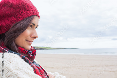 Photo: Woman in knitted hat and pullover at beach Woman in knitted hat and pullover at beach