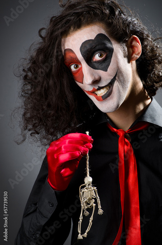Photo: Funny man with skeleton in hands Funny man with skeleton in hands