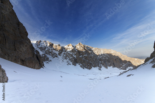 Photo: Two hikers on snowy mountains in morning Two hikers on snowy mountains in morning