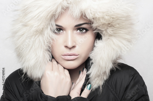 Photo: Fashion portrait of young beautiful woman with fur. hood Fashion portrait of young beautiful woman with fur. hood